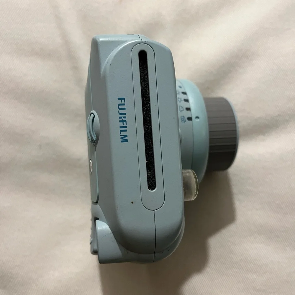 Polaroid camera: Fujifilm, Instax Mini 8. Light blue color, lightly used